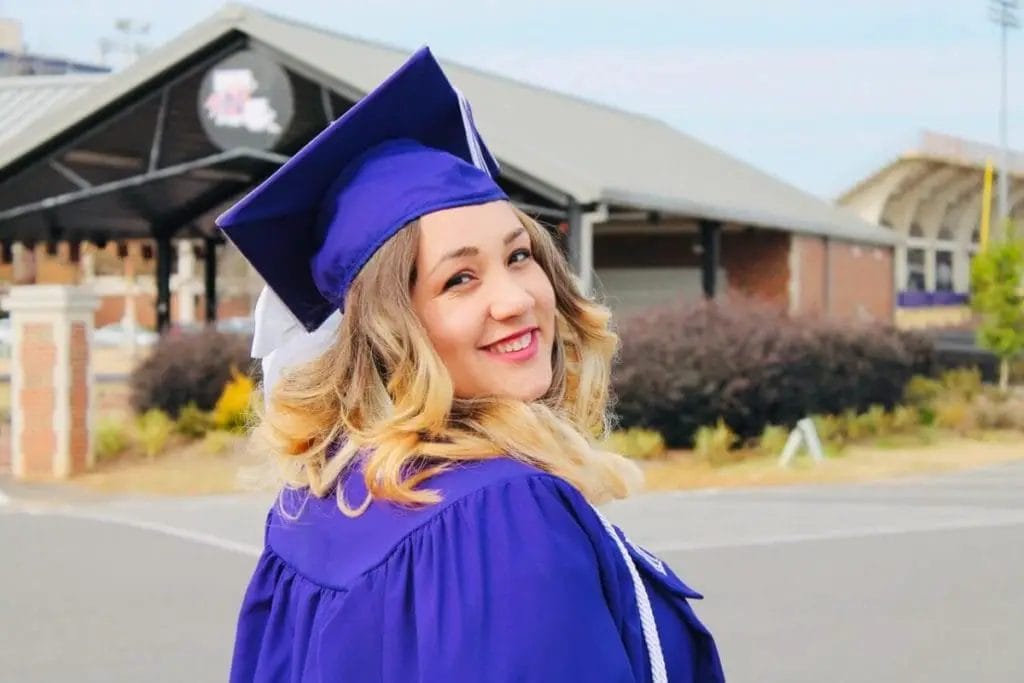 woman wearing purple mortar board and academic robe 1448258 scaled